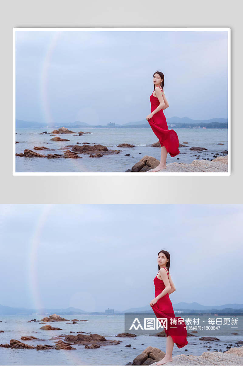 深圳较场尾海边礁石上的红衣少女手拿裙摆高清图片素材