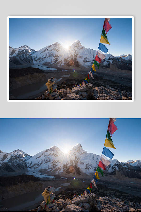 彩旗山峰光照雪山雪景摄影图片