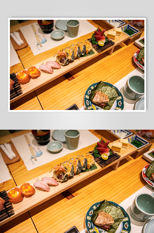 手握富贵卷日料日本料理美食摄影图片