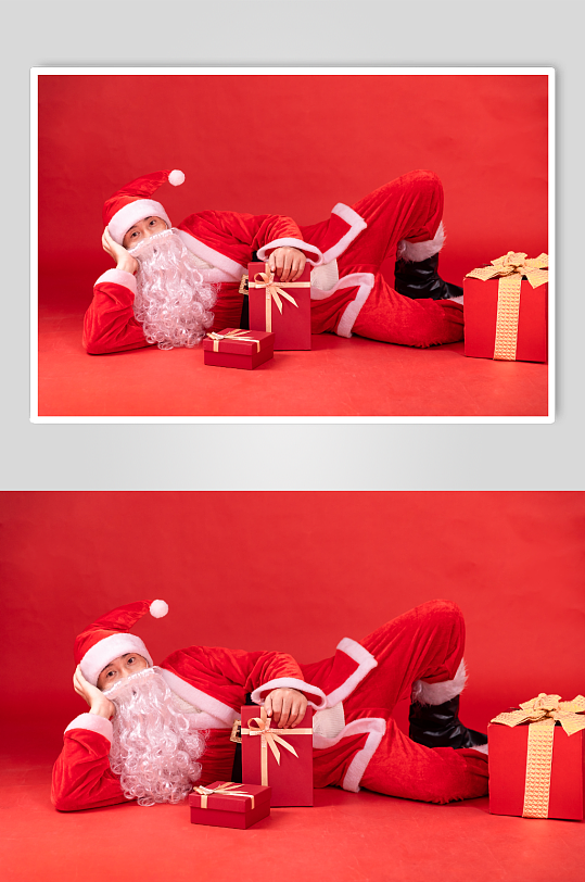 躺在红色背景上的圣诞老人摄影图片