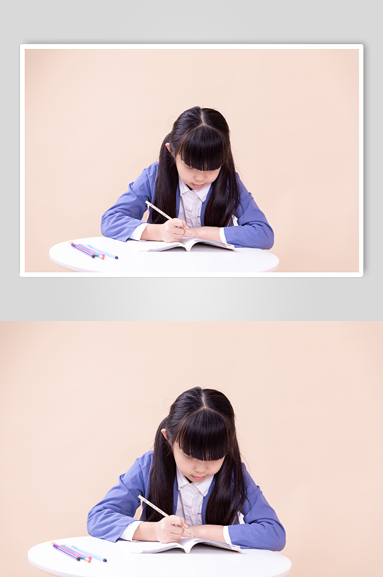 低头写作业的小学生小女孩摄影图