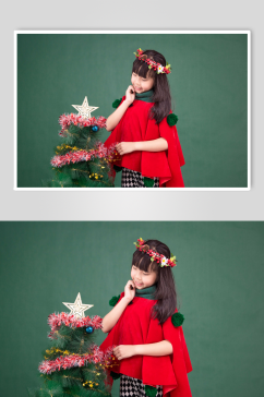圣诞树旁可爱的圣诞小女孩摄影图