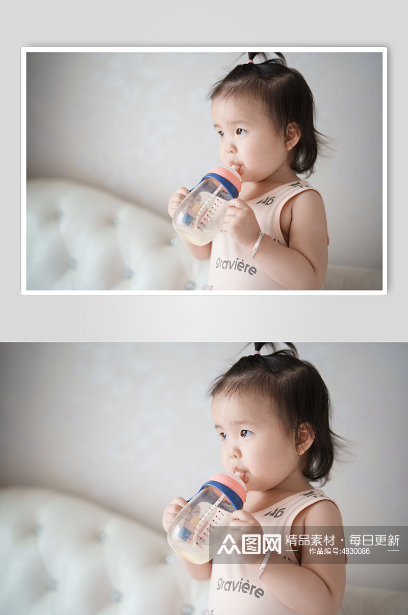 抱着奶瓶喝奶的婴儿摄影图素材