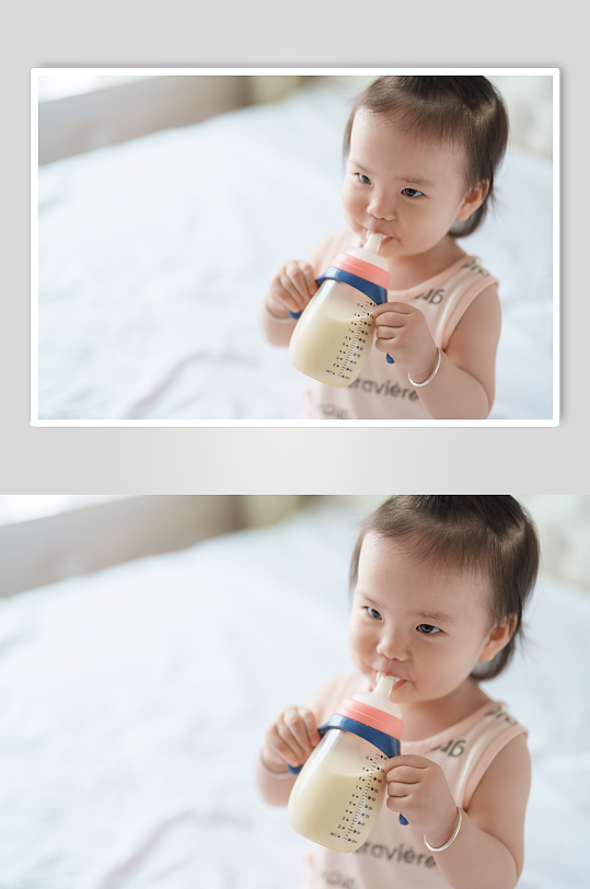 拿着奶瓶喝奶的小宝宝人像摄影图