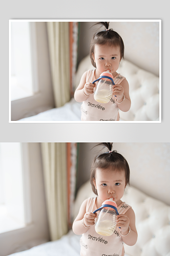 拿着奶瓶喝奶的小宝宝人人物摄影图