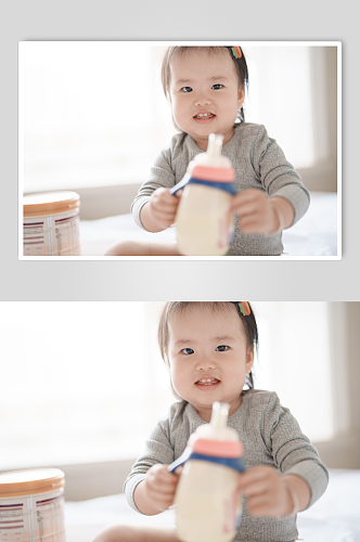 拿着奶瓶喝奶粉的小宝宝人物摄影图