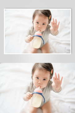 坐在床上喝奶粉的婴儿人物摄影图