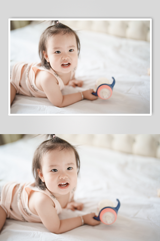 趴在床上手拿奶瓶的小宝宝摄影图-众图网