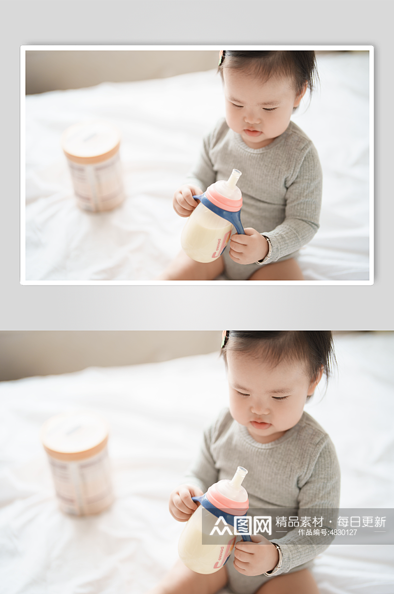 坐在床上喝奶粉的小宝宝摄影图素材