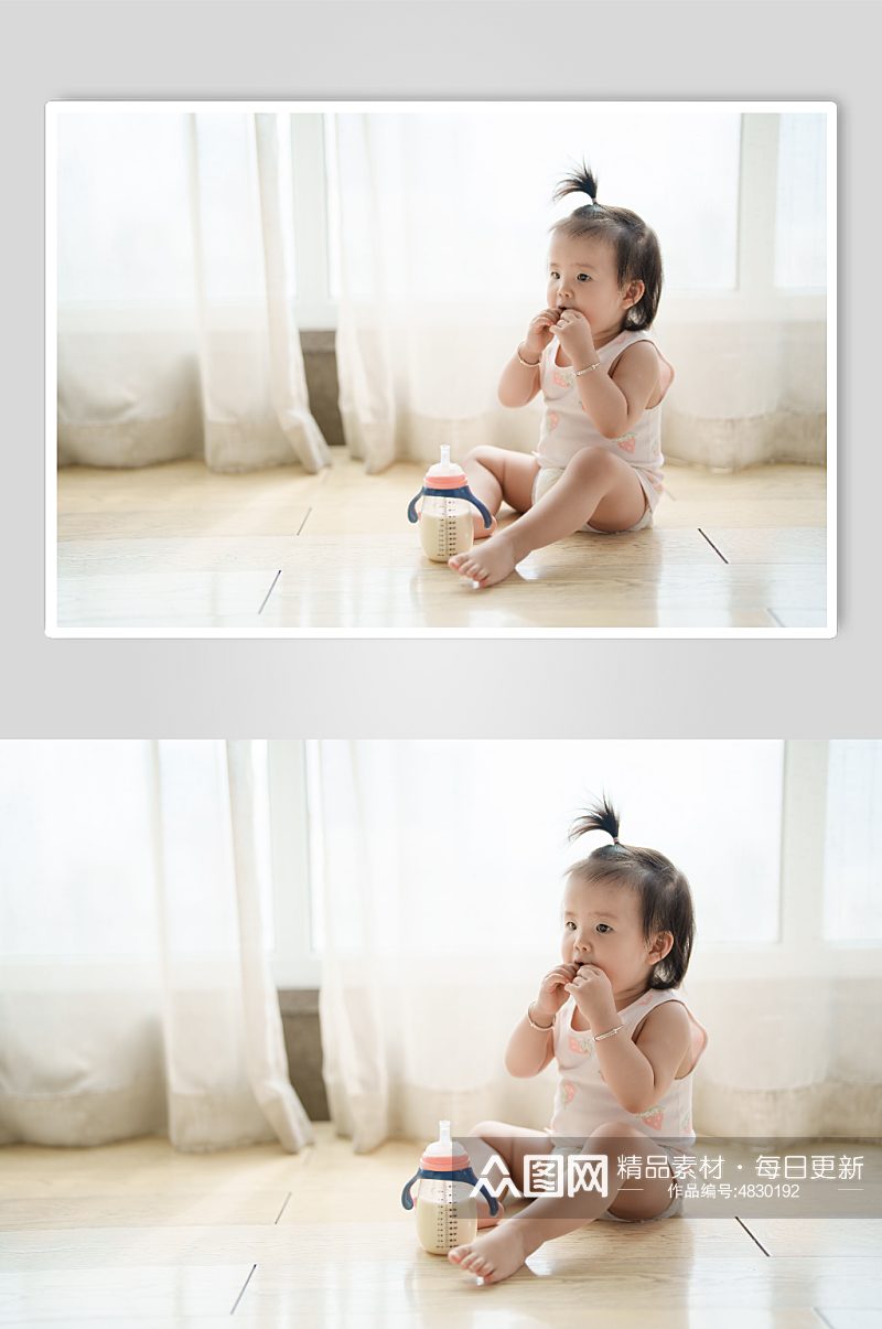 奶瓶放在地上玩耍的小宝宝摄影图素材