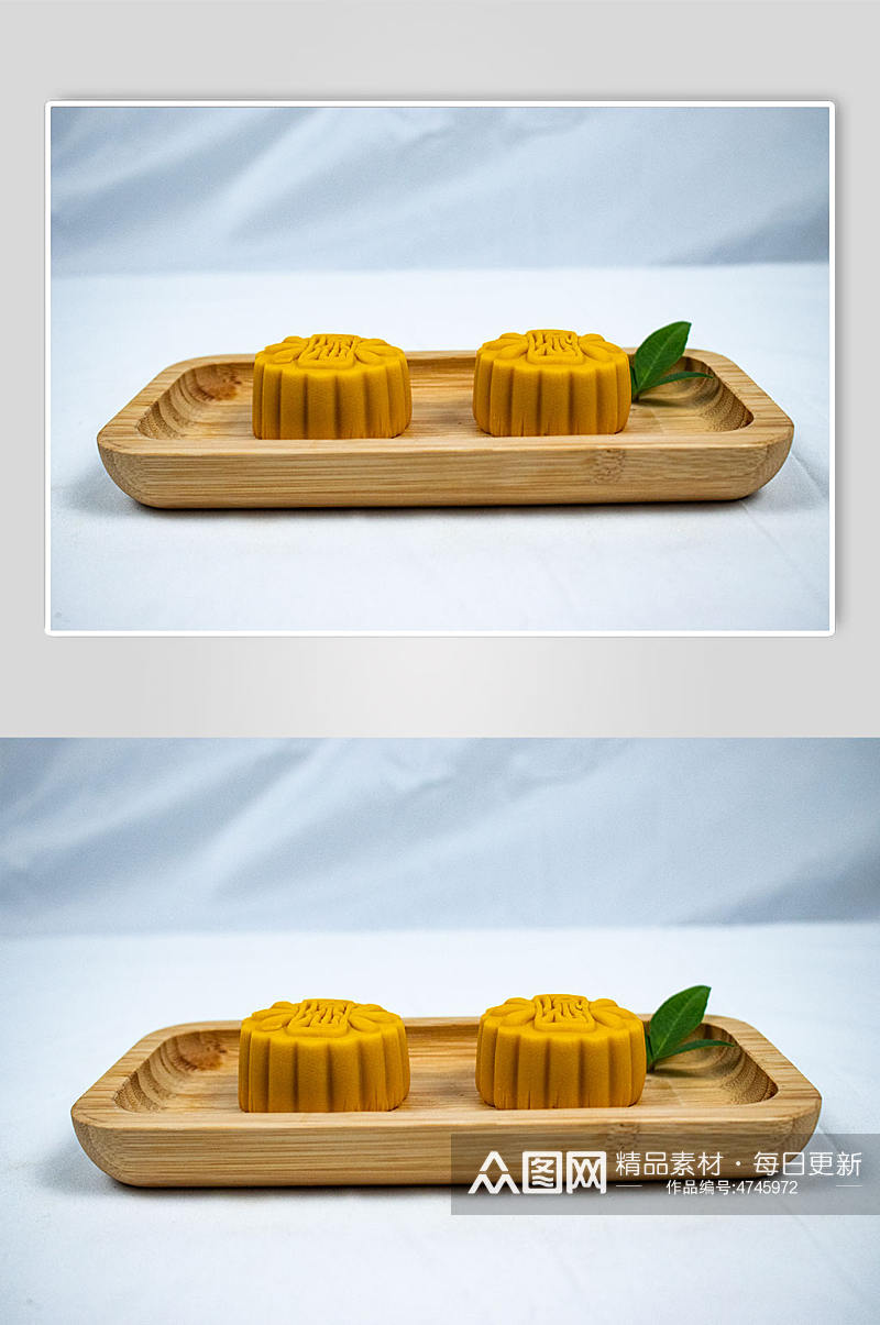 中秋节流心月饼美食树叶摄影图片素材