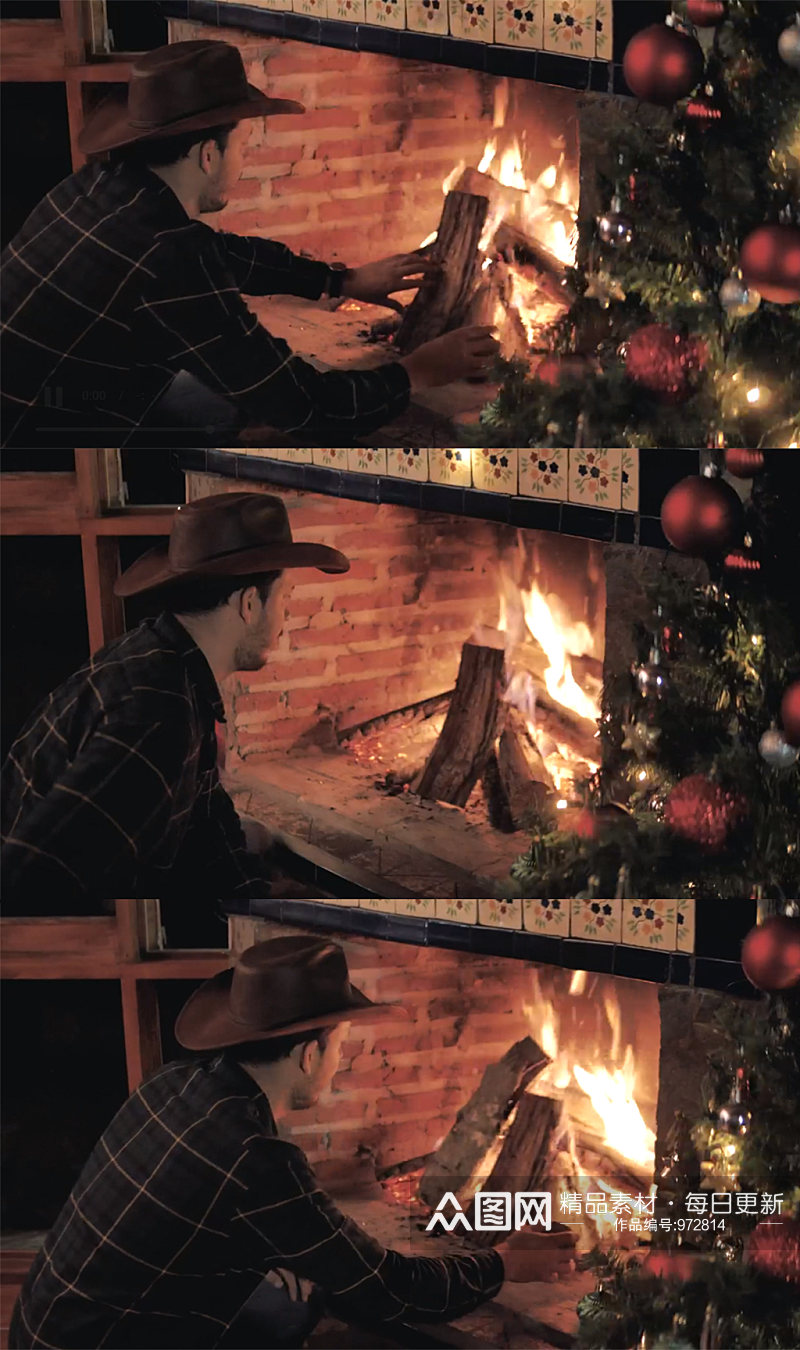 实拍男子在圣诞树旁的壁炉里添加柴火素材