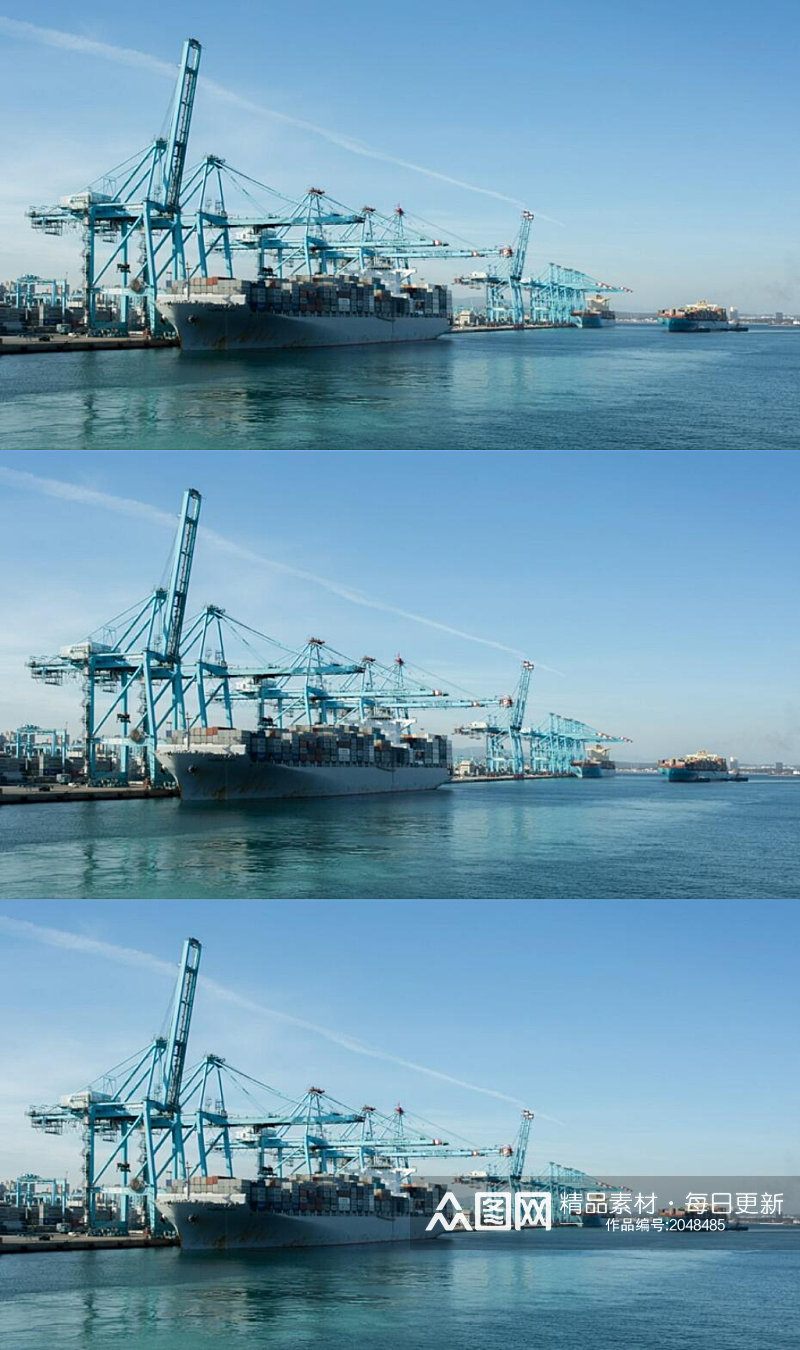 一艘货船正由大型蓝色起重机在码头卸货实拍素材