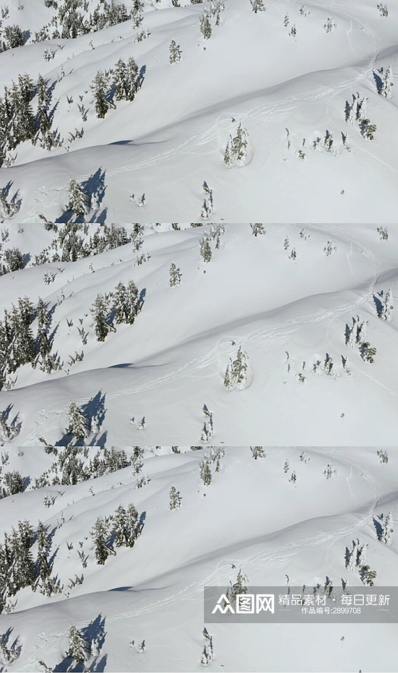 航拍冬季雪山山脉上的滑雪爱好者实拍视频素材