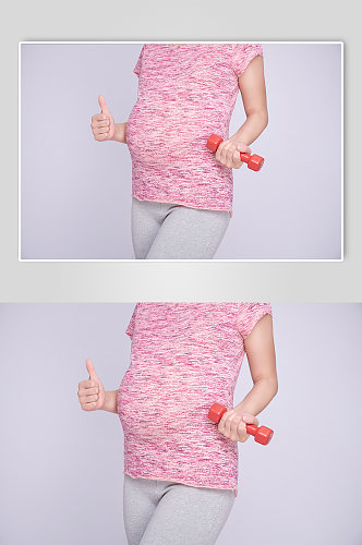手拿哑铃点赞运动孕妇人物摄影图
