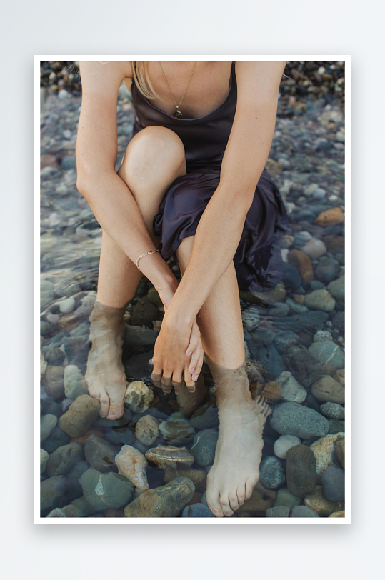 海边石滩上女子赤足静坐-众图网