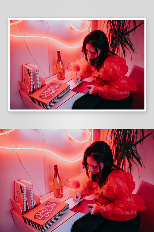 红光下女子书写圣诞贺卡-众图网