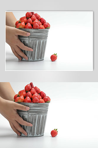 手拿桶装草莓水果食物物品摄影图片