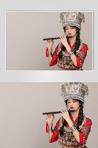 苗族少数民族少女吹笛银饰服饰摄影图片