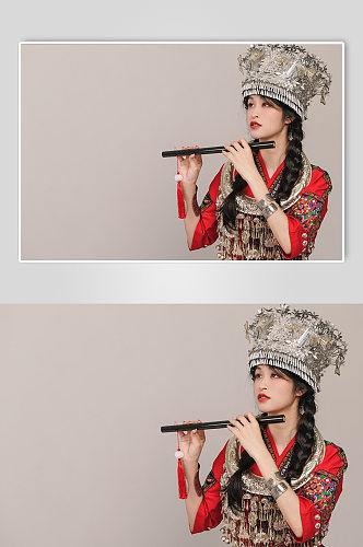 苗族少数民族少女吹笛银饰服饰摄影图片