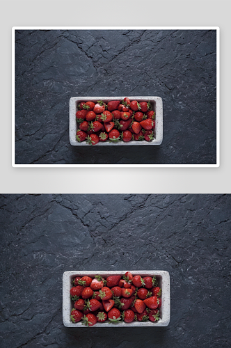 红色草莓在深色的石头表面高清底纹图片