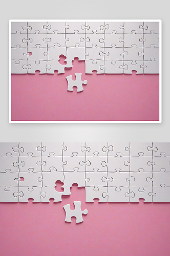 粉红色背景下组装白色拼图图片