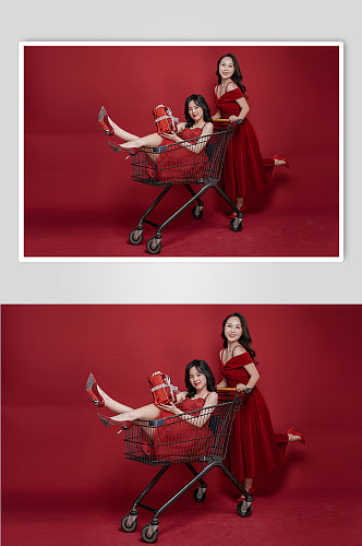 红裙双人女生手推购物车新年购物摄影图
