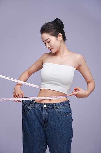 瘦身健康美体女性减肥量尺人物精修摄影图片