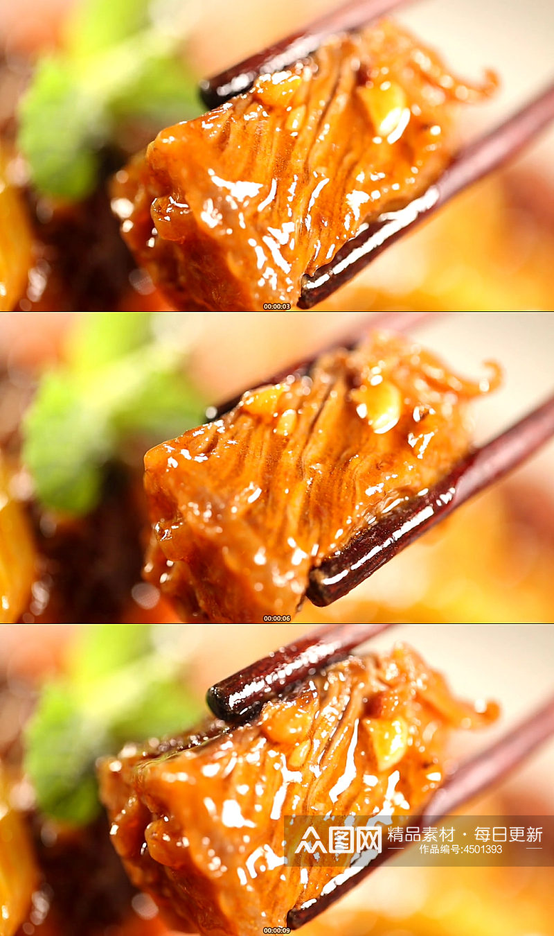 筷子夹起一块红酒牛肉实拍素材