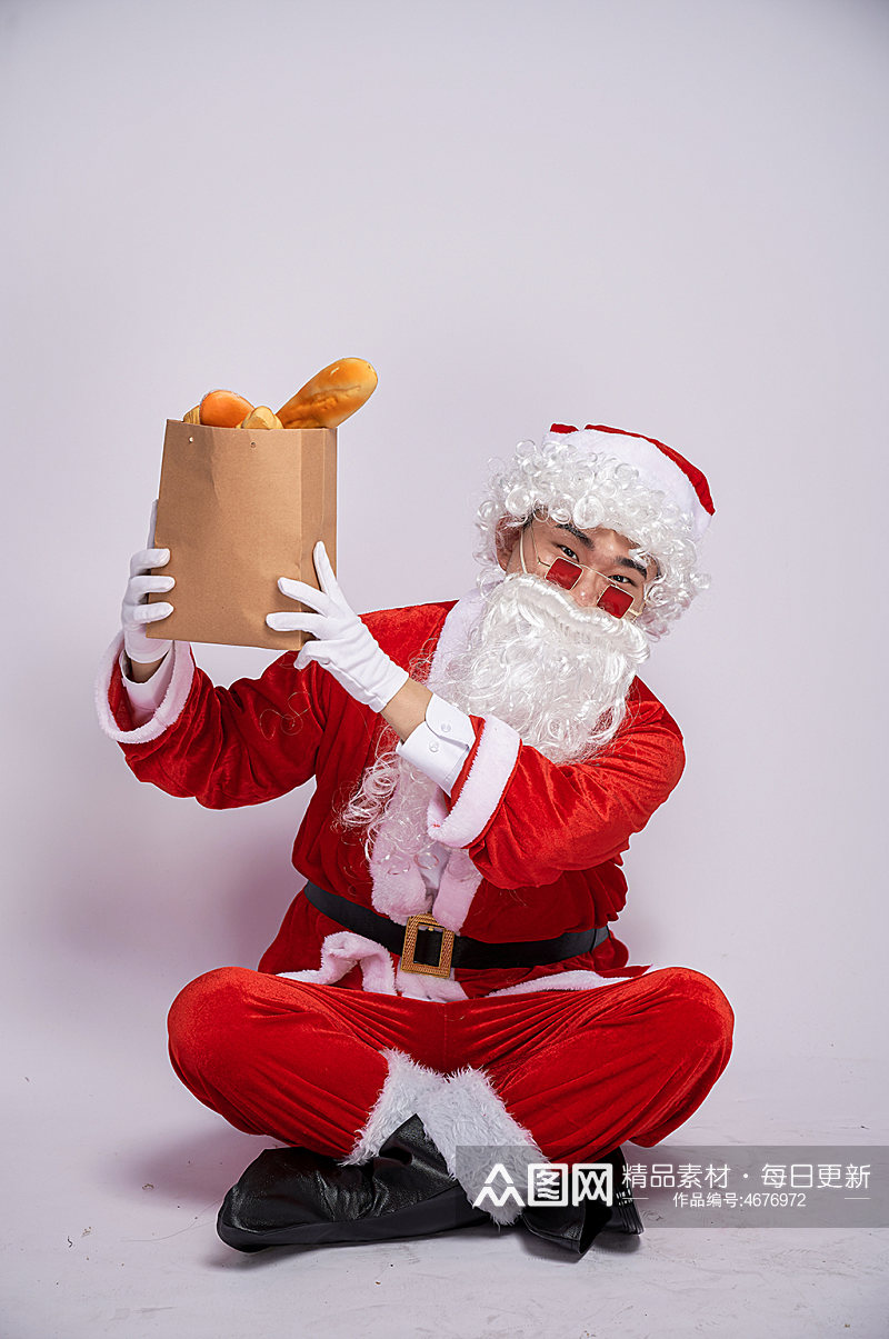 圣诞节圣诞老人坐着手举面包人物摄影图素材