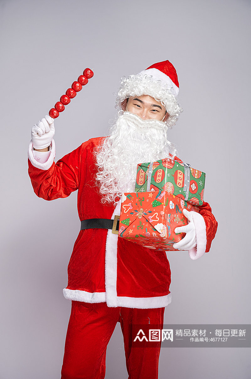 圣诞节圣诞老人手拿糖葫芦人物摄影图素材