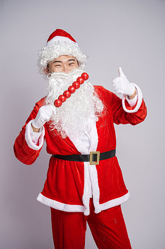 圣诞节圣诞老人拿糖葫芦人物摄影图