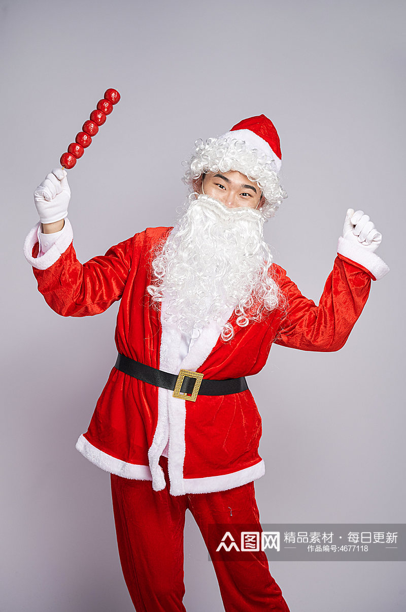 圣诞节圣诞老人站着手拿糖葫芦人物摄影图素材