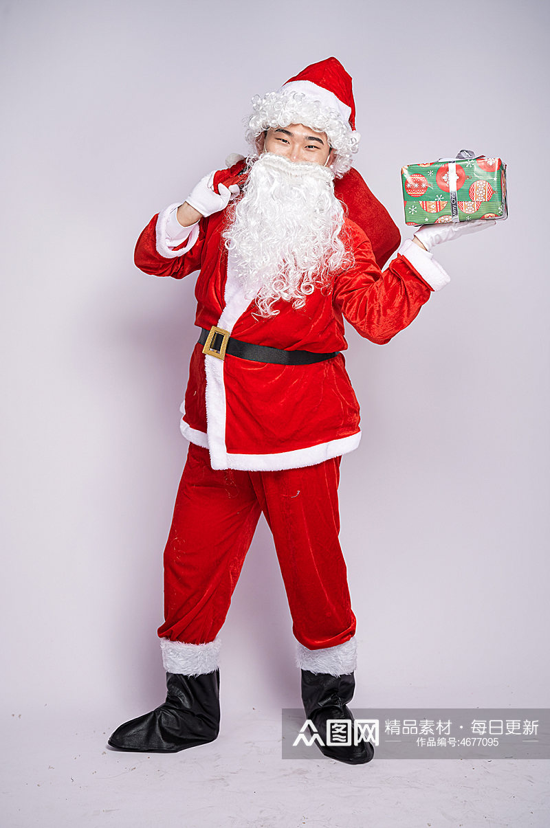 圣诞节圣诞老人背礼物手拿礼物袋人物摄影图素材