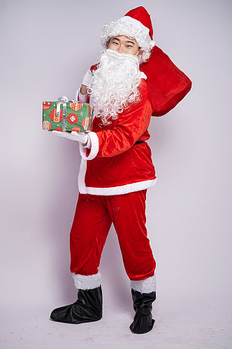 圣诞节圣诞老人背礼物手拿礼物袋人物摄影图