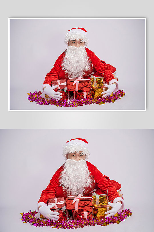 圣诞节圣诞老人蹲着抱礼物人物摄影图