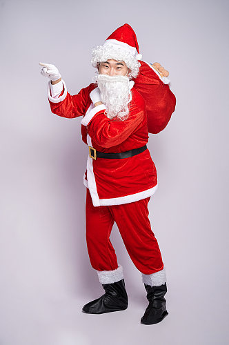 圣诞节圣诞老人站着背礼物人物摄影图