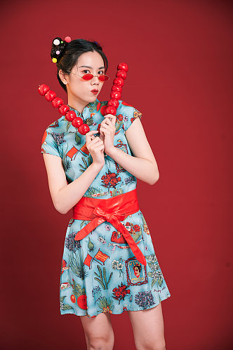 国潮美女拿糖葫芦创意旗袍女生摄影图