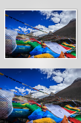 西藏高原雪上上飘动的经幡摄影图片